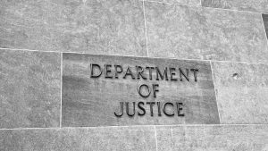 The Department of Justice name carved into the stone of its Washington DC headquarters