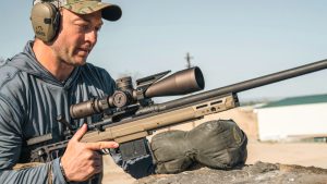 A competitor behind a precision rifle fitted with a Vortex Razor HD Gen III riflescope