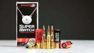 A box of Winchester Super Match competition ammunition with rifle, pistol and shotgun cartridges