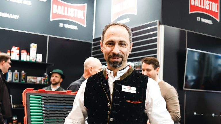 A Ballistol representative in a waistcoat on the company’s trade-show stand