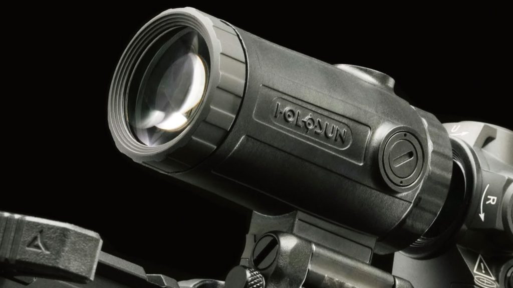A Holosun optic mounted on a rifle, against a black background