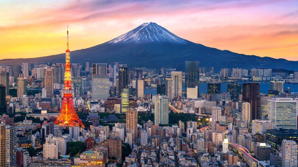 Tokyo skyline at dusk with Tokyo Tower lit up and Mount Fuji behind