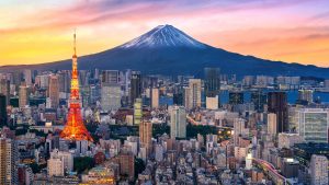 Tokyo skyline at dusk with Tokyo Tower lit up and Mount Fuji behind